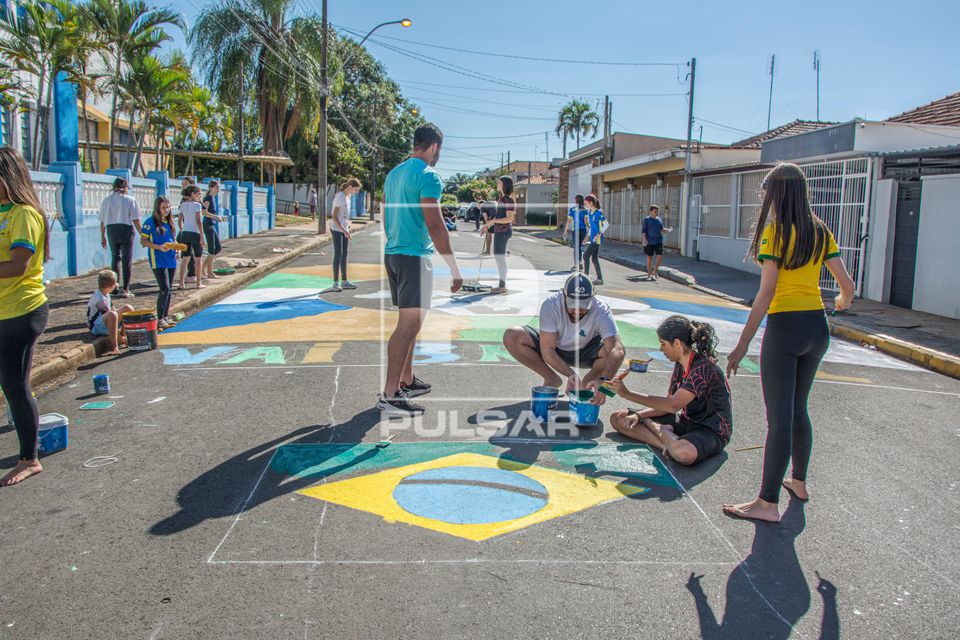 Moradores pintando a rua com tema da Copa do Mundo - centro da cidade