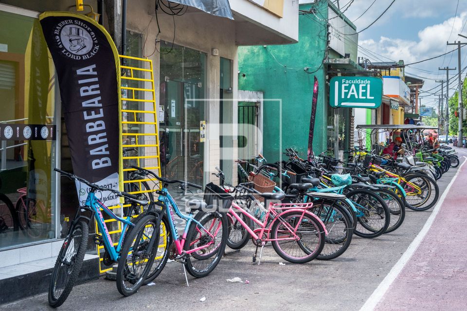 Bicicletas estacionadas em frente ao comércio - município não têm automóveis