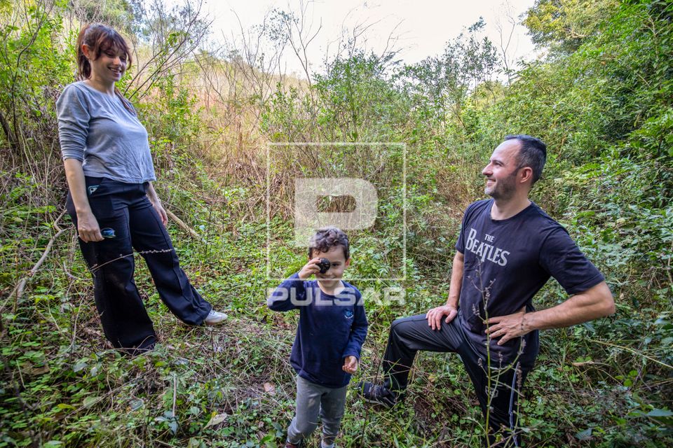 Família fazendo trilha em meio à vegetação de capoeira e mata atlântica