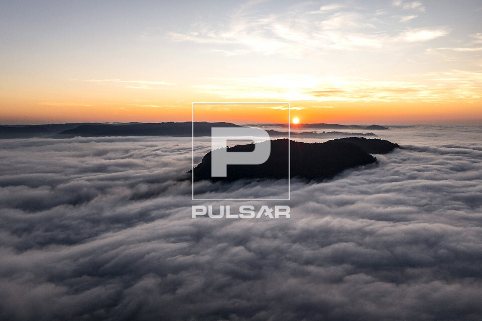 Vista de drone da Serra dos Agudos coberta por nuvens ao amanhecer
