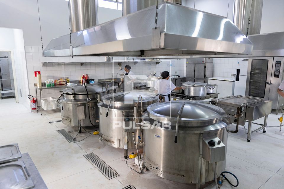 Caldeirões e coifas industriais na cozinha de restaurante de preço popular 