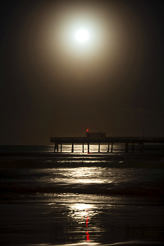 Reflexo da lua ao nascer na plataforma marítima da praia Atlântida - 