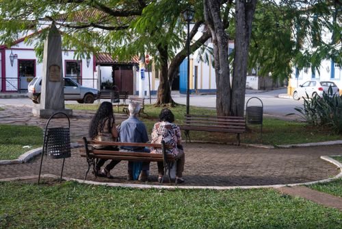 Família descansa em banco de praça