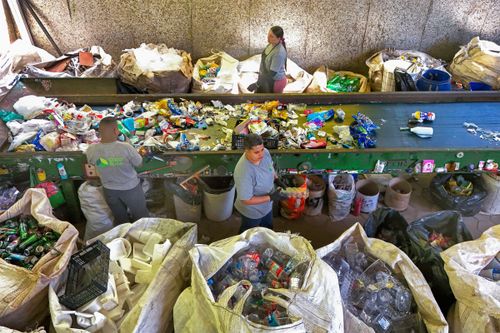 Vista de drone de esteira para separação de materiais recicláveis em cooperativa de reciclagem 