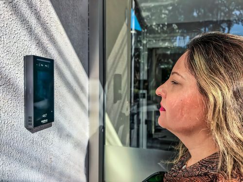 Mulher utiliza reconhecimento facial para entrar em prédio
